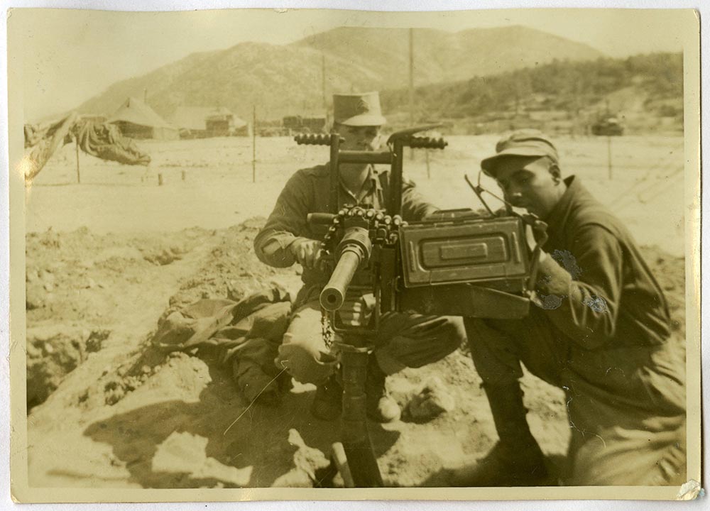Squad members David Brock and Robert Borders with a machine gun during Korean War